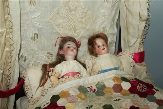 Miniature half Tester bed and 2 dolls